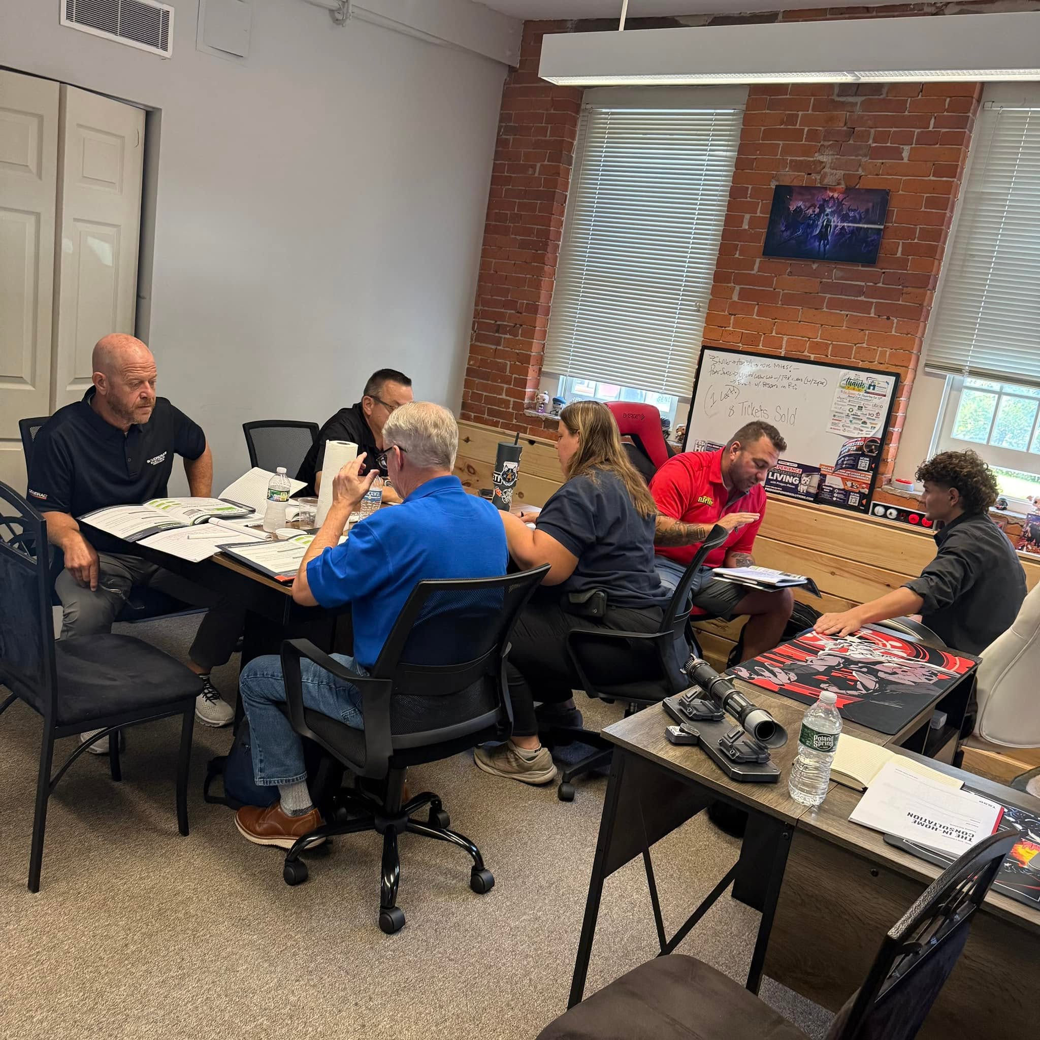 Bootcamp attendees working through training materials together around the table
